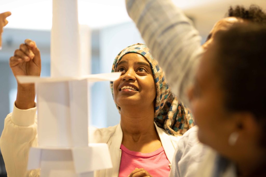 Fellows from The ROOM in Ethiopia building a paper tower