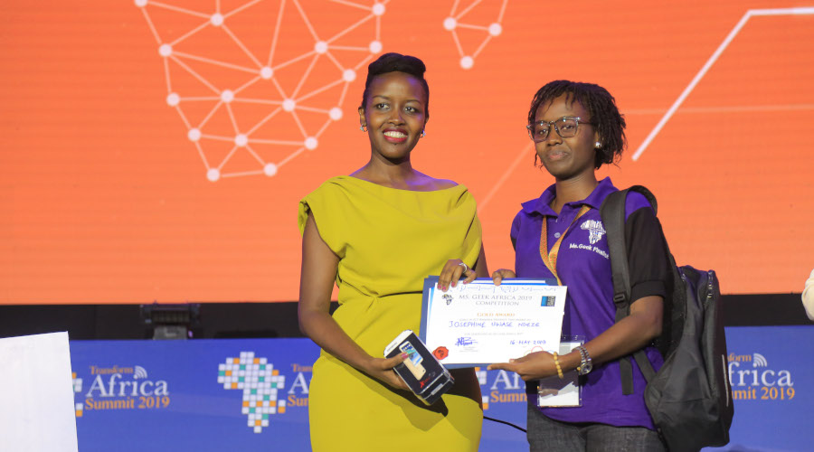 Minister Paula Ingabire presenting a certificate to a Ms Geek competition winner