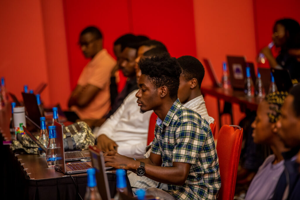 ALX Software Engineering learner working on his laptop at a live coding session in Kigali, Rwanda