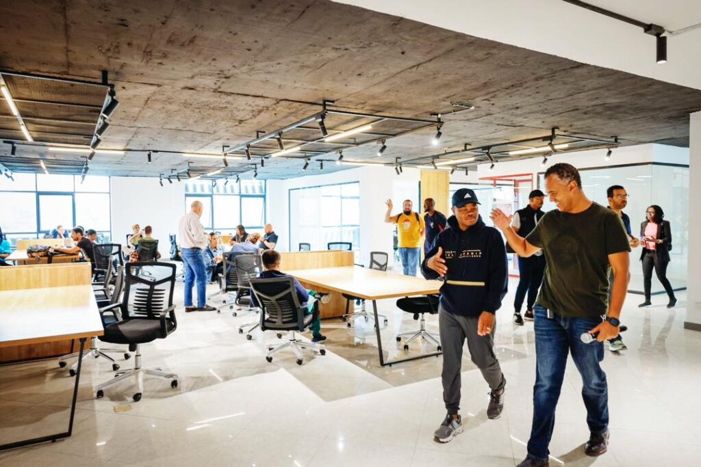 Founder of ALX, Fred Swaniker, and General Manager of ALX Ethiopia Mirafe Marcos in the middle of a handshake at the Addis hub or co-working space | Karibu 2023