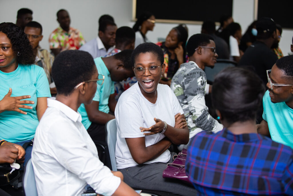 ALX graduates in Ghana talking to one another at a community Townhall