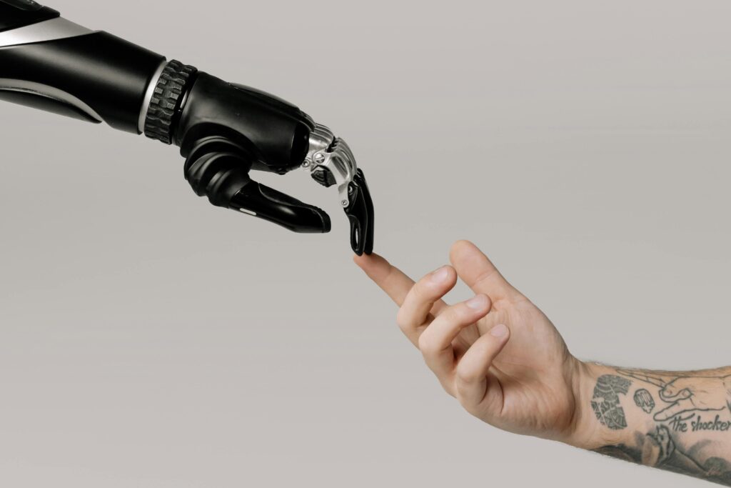 A robot hand and human hand are touching finger tips