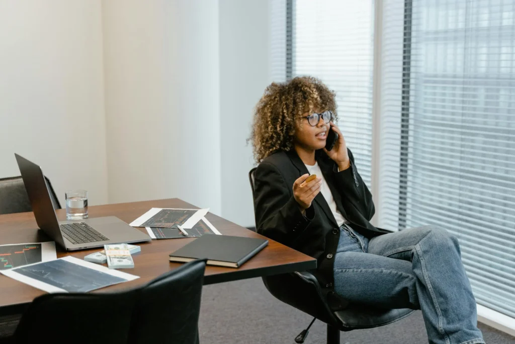 Women sitting in a meeting room on the phone.