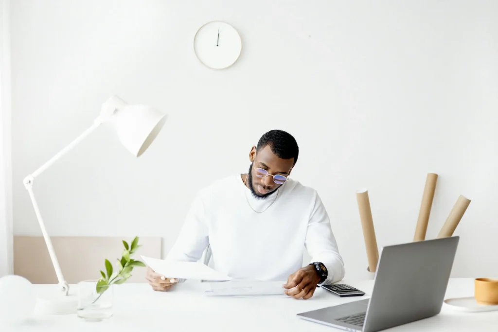 Man sitting at a desk looking at papers.