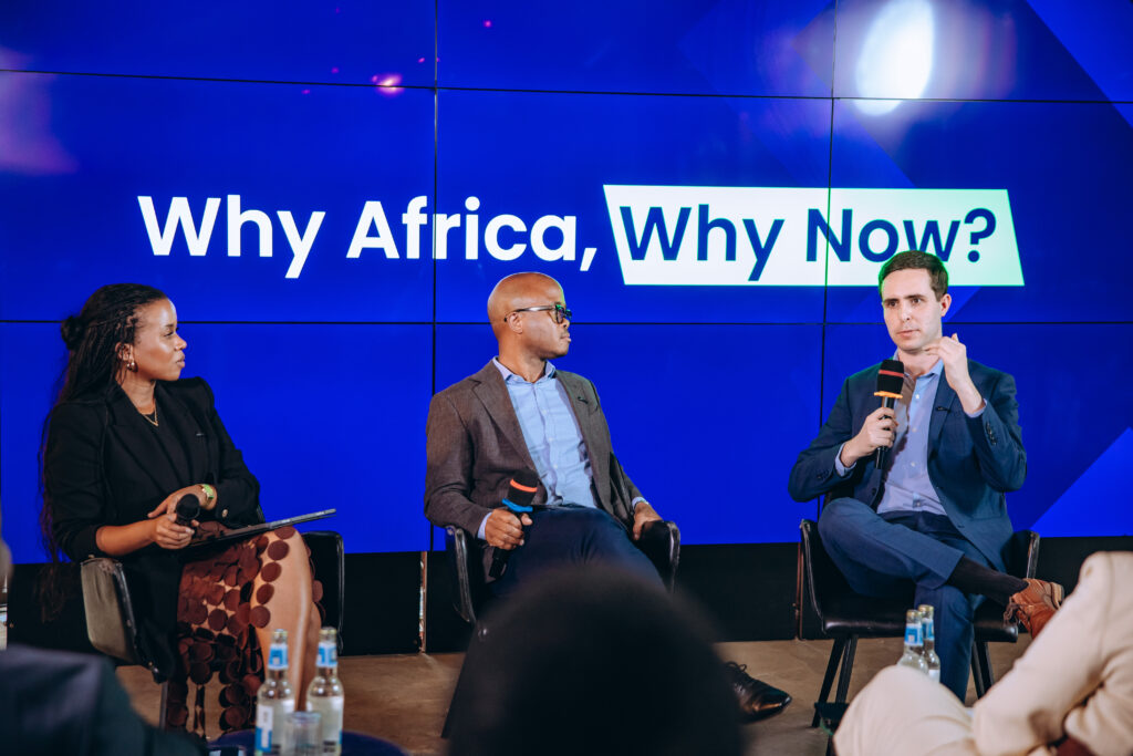 A panel discussion featuring Fred Swaniker at the ALX x Anthropic event in Kigali. The screen behind them reads, "Why Africa, Why Now?"